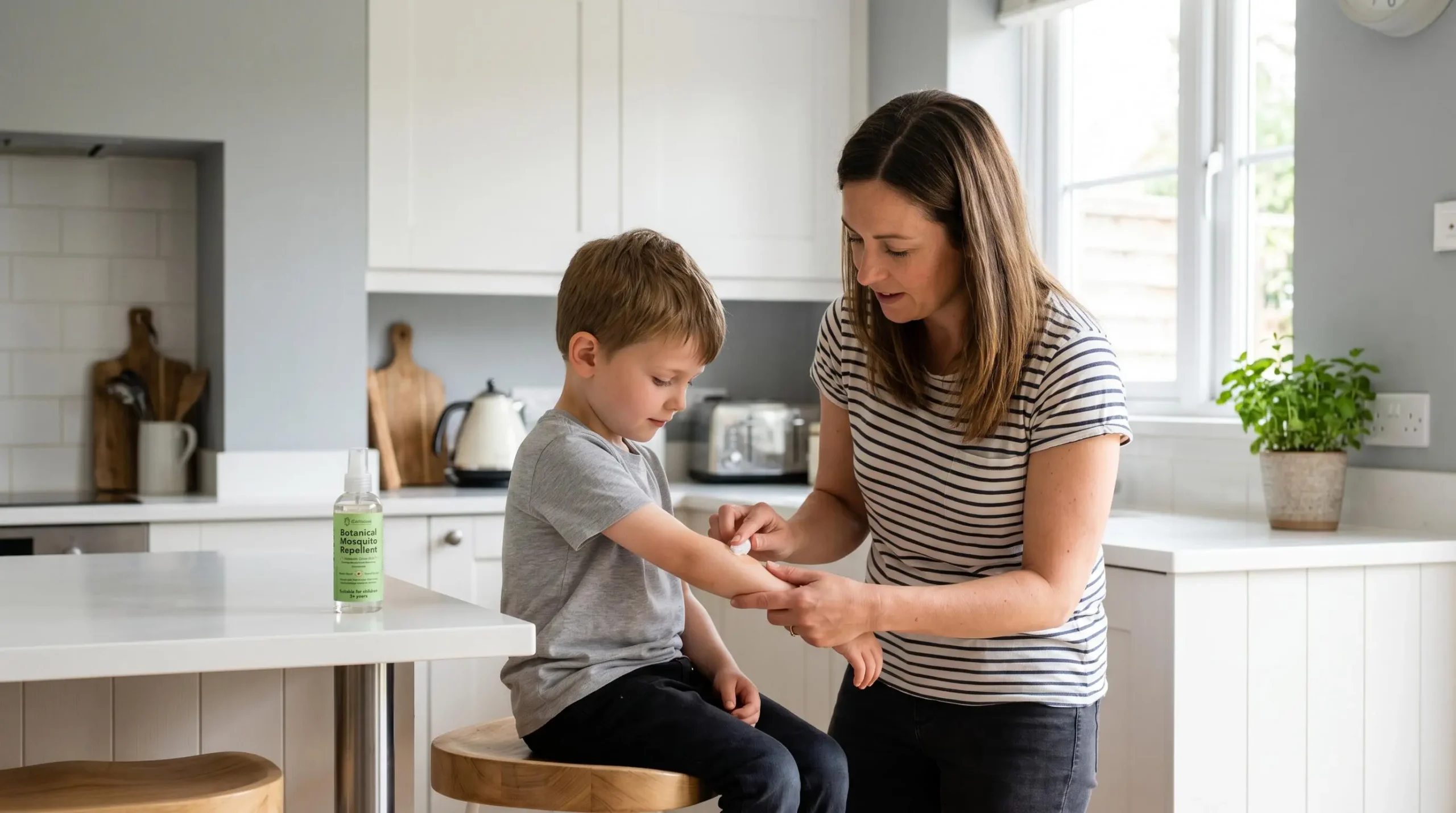Parent applying natural mosquito repellent patch test to child's inner forearm in bright domestic UK bathroom setting, demonstrating safe age-appropriate application protocol with visible product age-suitability labelling